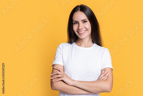happy woman in casual shirt isolated on yellow background with copy space.