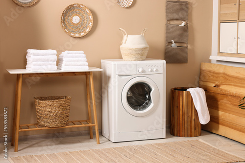 Stylish laundry room with modern washing machine. Interior design