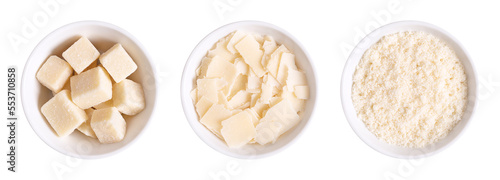 Grana Padano cheese, chunks, flakes and grated, in white bowls. Italian hard cheese, similar to Parmesan, with a savory flavor and a crumbly, slightly gritty texture, made from unpasteurized cow milk.
