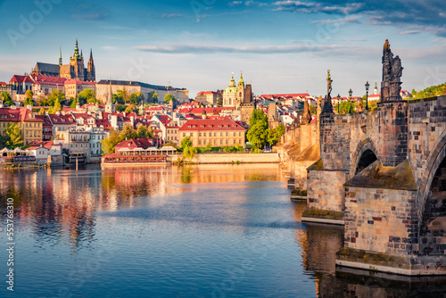 Exciting spring cityscape Prague with Charles Bridge and Castle and St. Vitus cathedral on the shore of Vltava river. Sunny morning scene of capital of Czech Republic, Europe.