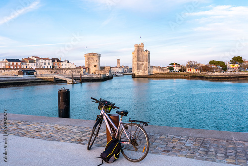 La Rochelle old harbor. Rear view of a bicycle looking at city view while standing on observation point.
