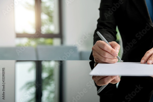 Businesswoman hand writing on paper