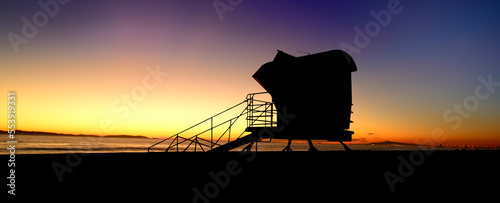 Sandman: Sunset near a lifeguard tower in Huntington Beach, California