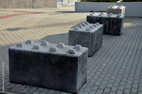 entrance barrier made of a block of concrete in the shape of a rectangular cube with projections in the shape of a kit. Entire walls can be folded. heavy obstruction of entrance to pedestrian zone 