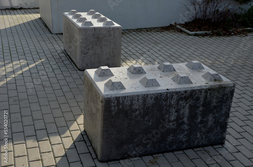 entrance barrier made of a block of concrete in the shape of a rectangular cube with projections in the shape of a kit. Entire walls can be folded. heavy obstruction of entrance to pedestrian zone 