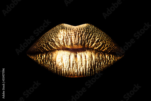 Golden lips isolated on black background. Luxury glamour art mouth. Clipping path gild lips.