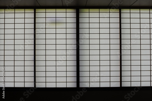 Rectangular and square Japanese shoji paper window frame with partitions with light in Japan