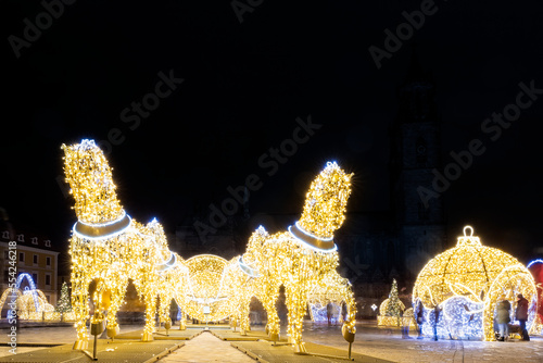Scenic art light led lamp decoration figures of horse carriage, christmas tree bowl on Magdeburg Dom square. Light world lichterwelt city new year xmas in Germany Saxony-Anhalt