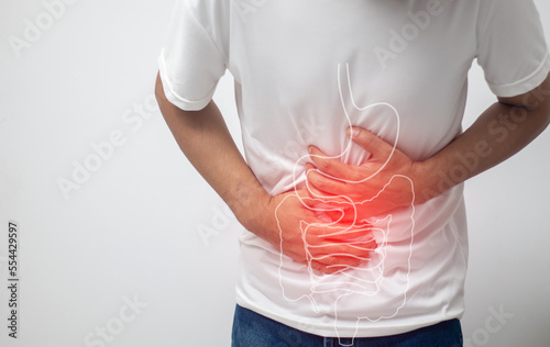 man having abdominal pain on white background