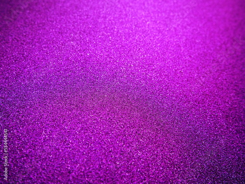 Purple shiny bokeh abstract background. Pink - lilac paper with sparkles. Festive backdrop.