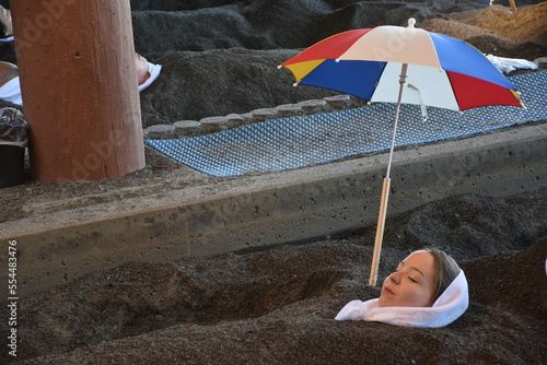 Ibusuki - Unique Onsen Town in Kagoshima, healthy sand and hot spring baths at the coastlinne, people wearing yukata laying in the sand under umbrella
