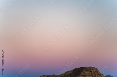 Iconic bardenas desert mountain at sunset with pink sky