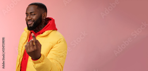 Cheeky flirty black bearded guy asking come closer beckon index finger camera smiling make smug face have plans for you alluring join, standing pink background devious grin