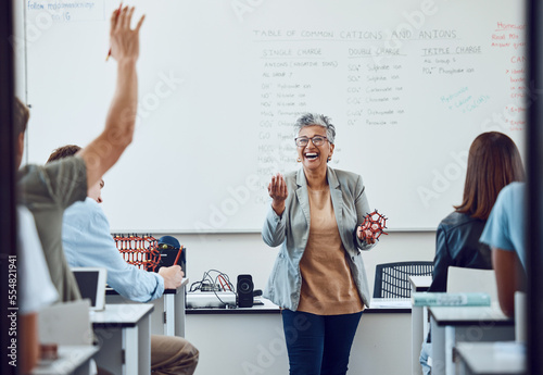 Classroom, teacher and science question at school university or college with dna model in education, learning and teaching. Physics professor with students happy for development or knowledge trust