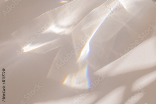 Sunlight background, abstract backdrop with light and shadow, glare and shine on paper texture, rainbow flare, beige color trend aesthetic wallpaper. Natural beams light, caustics effect