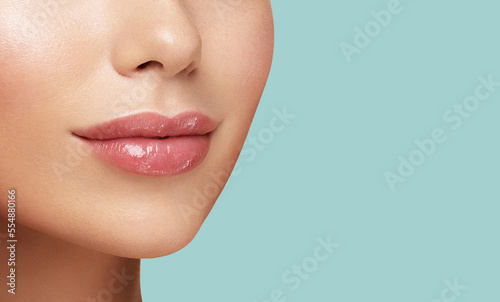 Close up photo of women lips. Cosmetology beauty injetion procedure. Hyaluronic acid. Lip protection balm. Hygienic lipstick
