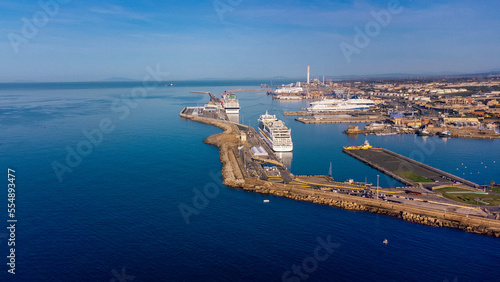 Panoramic view of the city of Civitavecchia with the adjoining tourist port and Forte Michelangelo. Emerald sea and view with tropical palm trees.