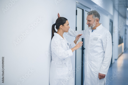 Female doctor rejecting flirty behavior of her male colleague