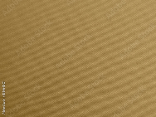gold color velvet fabric texture used as background. blond color fabric background of soft and smooth textile material. There is space for text.
