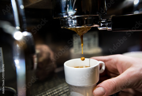 Espresso coffee dripping from machine