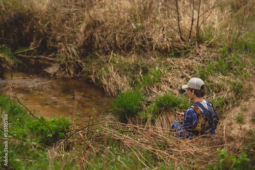 Young Man fishing in creek