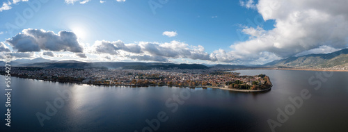 Greece, Ioannina city. Aerial view panorama of Giannena and Lake Pamvotis, cloudy blue sky.