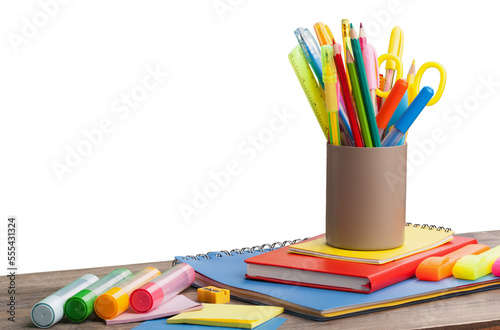 Colored school supplies on wooden table