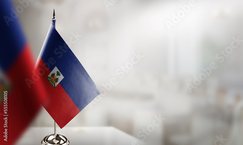 Small flags of the Haiti on an abstract blurry background