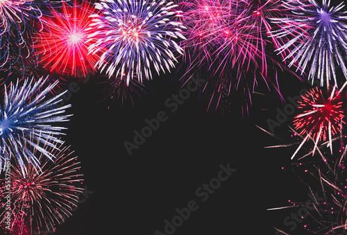 Background of fireworks in the night sky. New Year's celebration invitation concept.