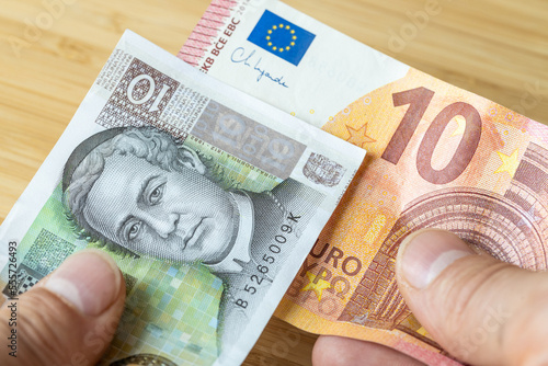 Money in hand, croatian kuna and euro, the concept of Croatians joining the euro zone, exchanging banknotes, changing the currency system