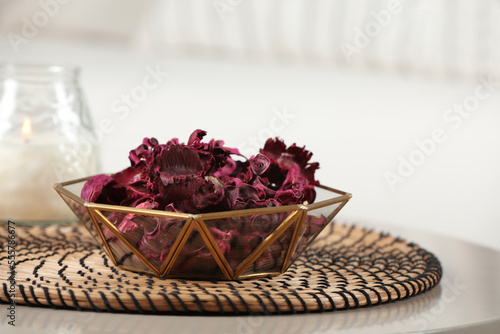 Aromatic potpourri of dried flowers in bowl on white table indoors