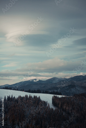 Old mountains in winter landscape photo. Beautiful nature scenery photography with cloudy sky on background. Idyllic scene. High quality picture for wallpaper, travel blog, magazine, article