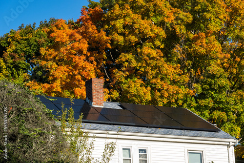 House with solar panels on the roof in autumn, Water Town, Massachusetts, USA