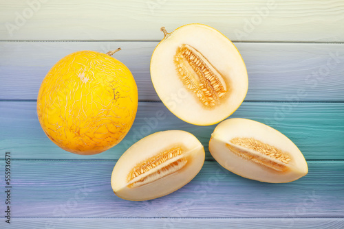 sliced yellow melon on wood background top view