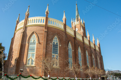 Exterior view of the St. Mary Basilica (Our Lady of Sorrows Cathedral) with semi-circular apsidal end, ornamental pinnacles, and buttresses erected in 1837 in Natchez, Mississippi, USA