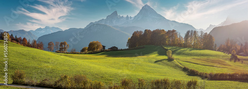 Scenic image of European Alps. Panoramic view of mountain scenery in the Alps with fresh green meadows and majestic rocky mount on background. National Park Berchtesgadener Land, Bavaria, Germany