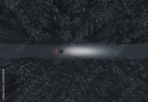A car trip at night in the winter forest. Aerial view