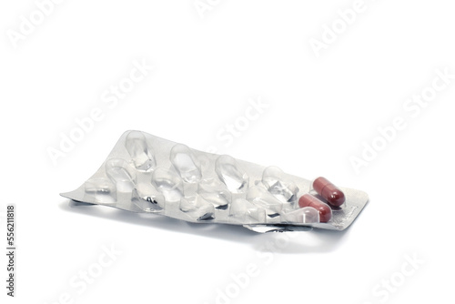 Empty medicine textured silver blister or package with two pills. Concept image to lack of development of pills in crisis time.