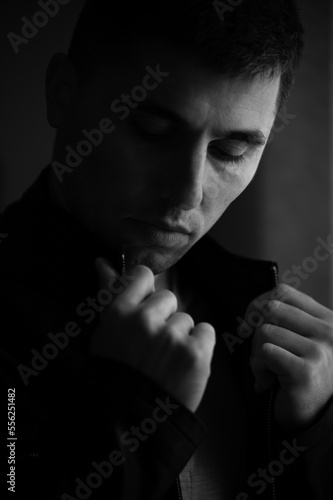 Monochrome portrait of a man with light from the window.