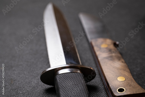 Handmade hunting knife on a black background. Leather scabbard handmade. high carbon steel