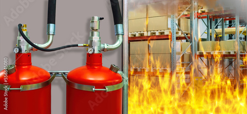 Fire inside warehouse. Fire extinguishers are fixed on wall. Red fire extinguishers close up. Burning warehouse with boxes. Flames are spreading near storage shelving. Flame extinguishing equipment