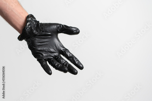 human palm wearing black latex glove isolated