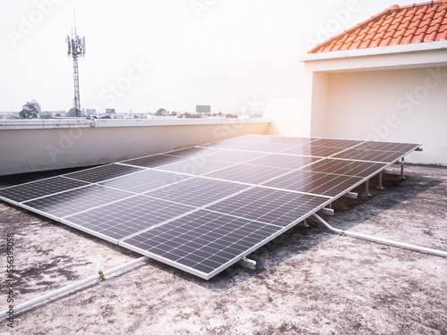 Solar Panels Solar Cells on Rooftop with Sun Overlight Day,New Design Plant Smart Solar System Micro Inverter Solar Panels Energy on Roof House,New Technology Electric for Eco Environment ecology.