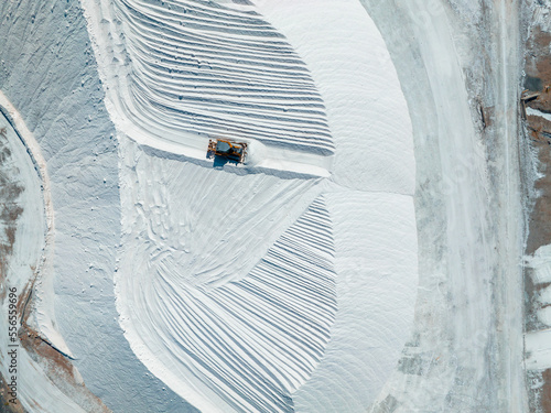 Salt Lake City, Utah landscape with desert salt mining factory at lake Bonneville with piles of white mineral and industrial equipment