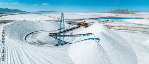 Salt Lake City, Utah landscape with desert salt mining factory at lake Bonneville with piles of white mineral and industrial equipment