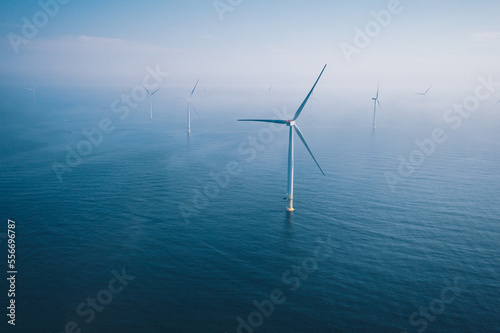 Wind turbine. Aerial view of wind turbines or windmills farm field in blue sea in Finland.