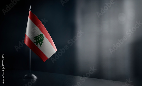 Small national flag of the Lebanon on a black background