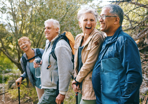 Nature, hiking and happy senior friends bonding, talking and laughing at comic joke in forest. Happiness, fun and group of elderly people trekking together for health, wellness and exercise in woods.