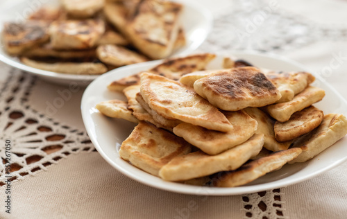 Podpłomyki, proziaki - polish type of soda bread, flat bread, polish cousine pankaces displayed on plates in home, homemade snacks, polish traditional regional cuisine