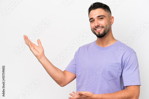 Young Arab handsome man isolated on white background extending hands to the side for inviting to come